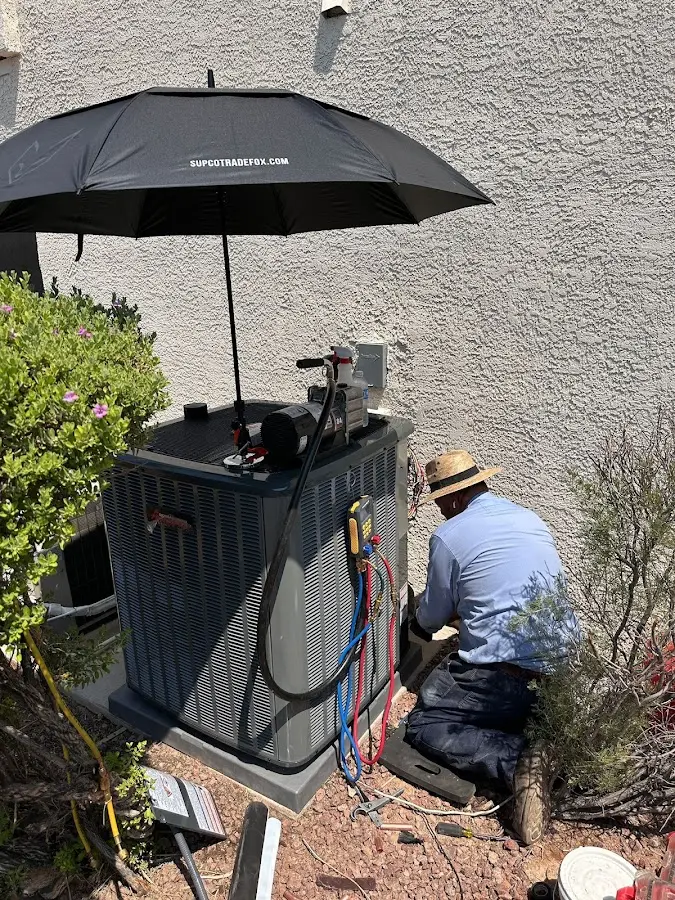 HVAC technician performing outdoor AC maintenance in Converse